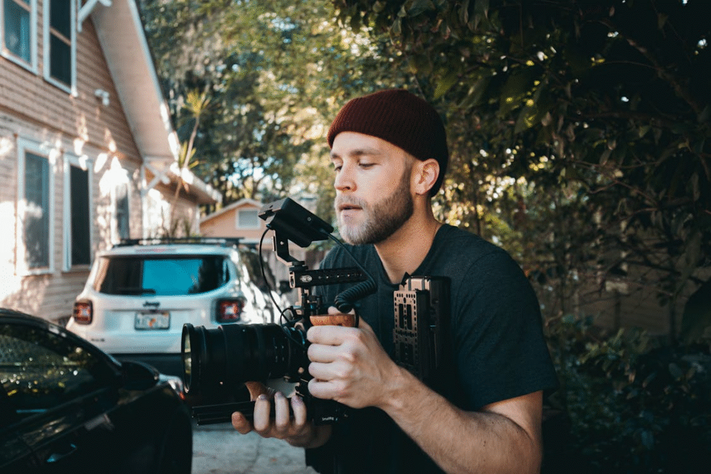 a man recording a video outdoors.