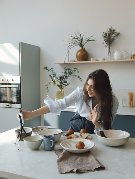 a woman in the kitchen recording content.