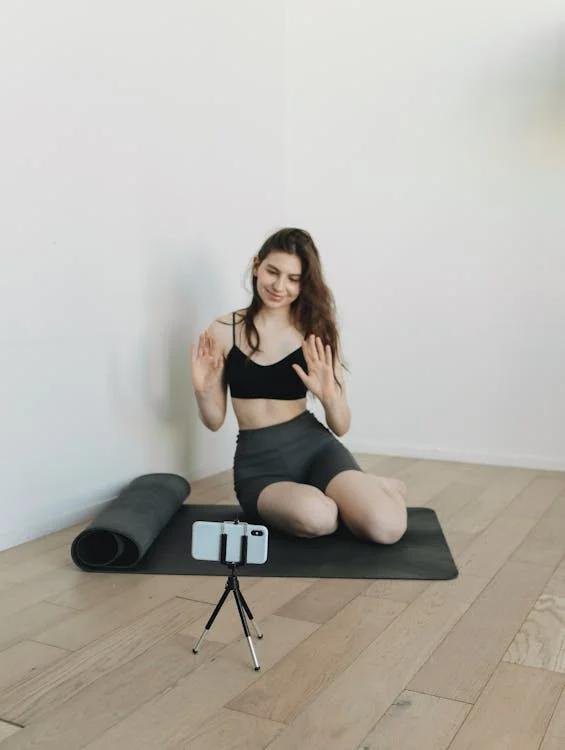 a content creator filming a workout video for her followers