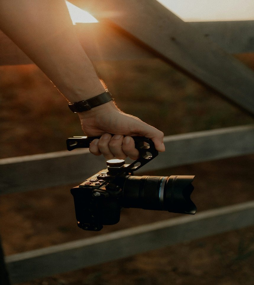 A person holding a camera in their hands.
