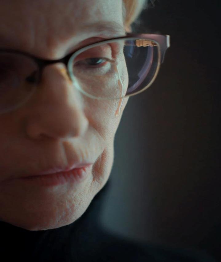 This photo shows a woman looking deeply emotional with tears on her cheeks