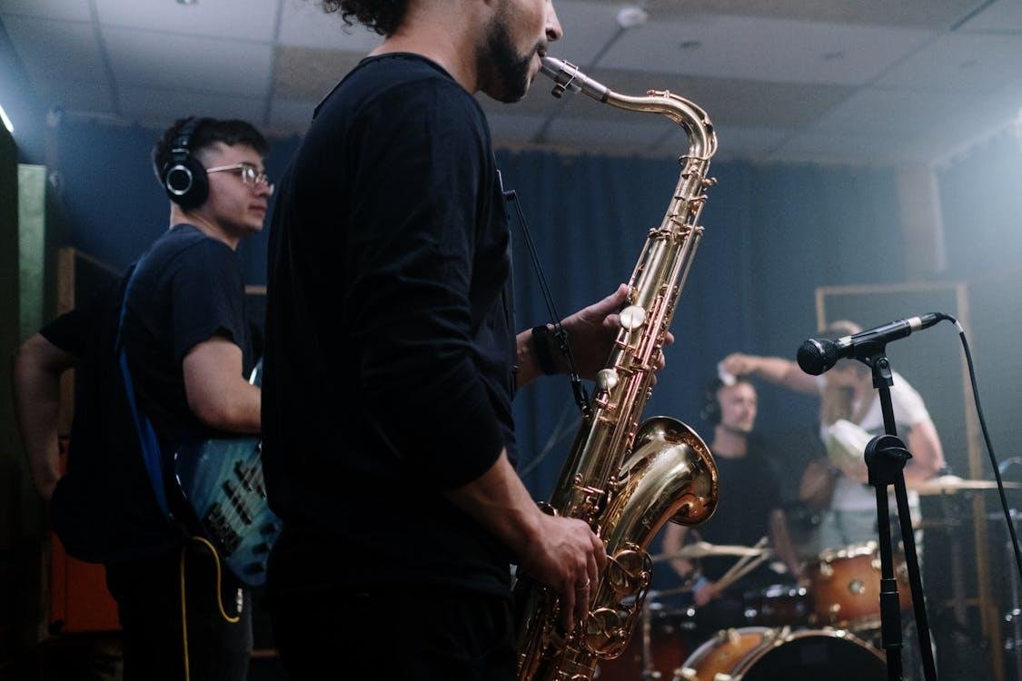 A person playing a saxophone in front of a microphone