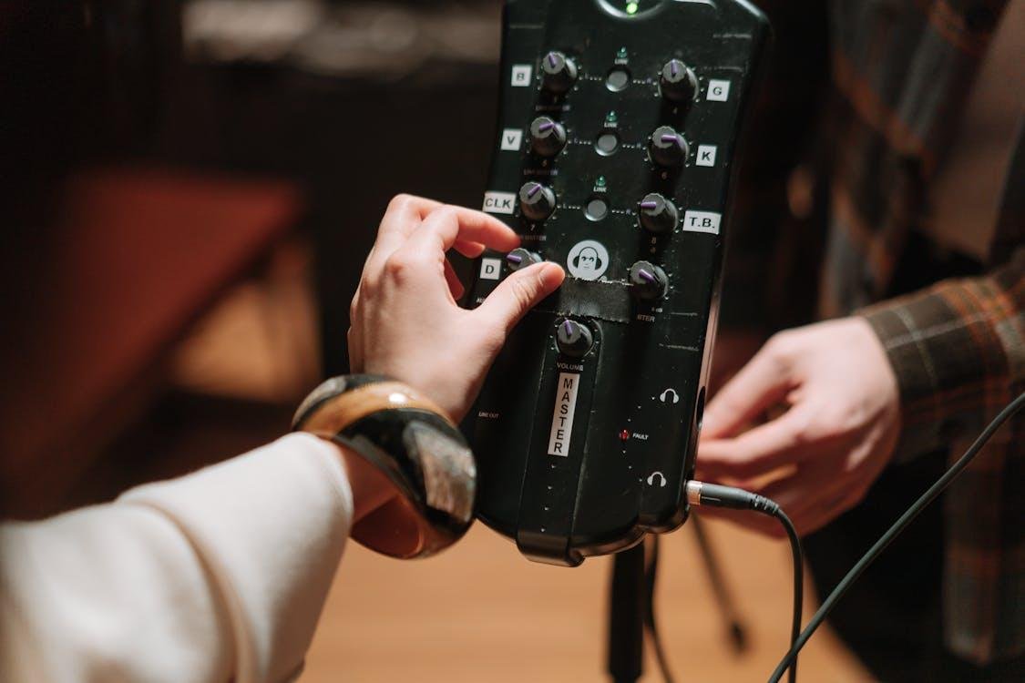 A hand on an audio machine