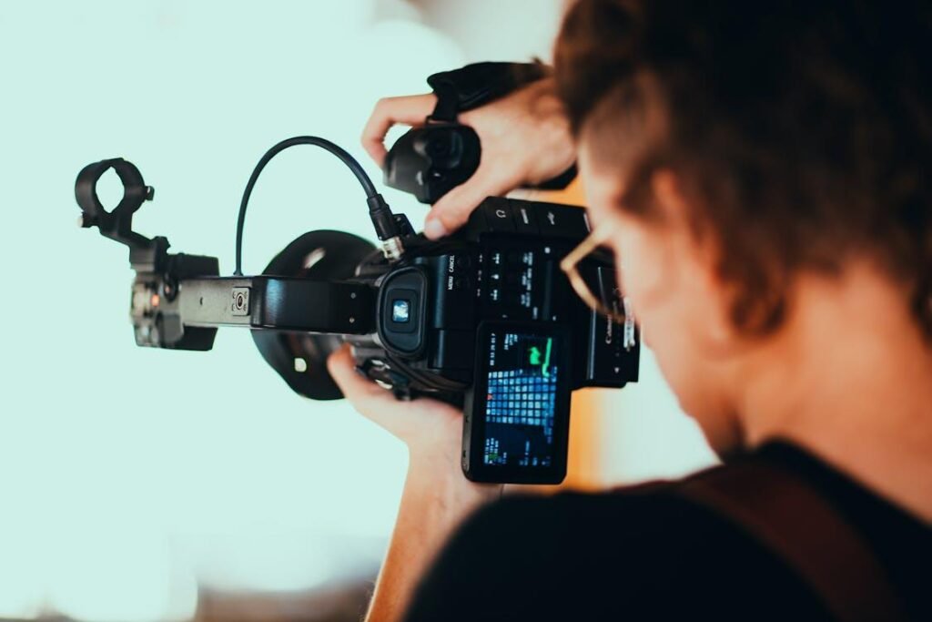 A person holding a black camera
