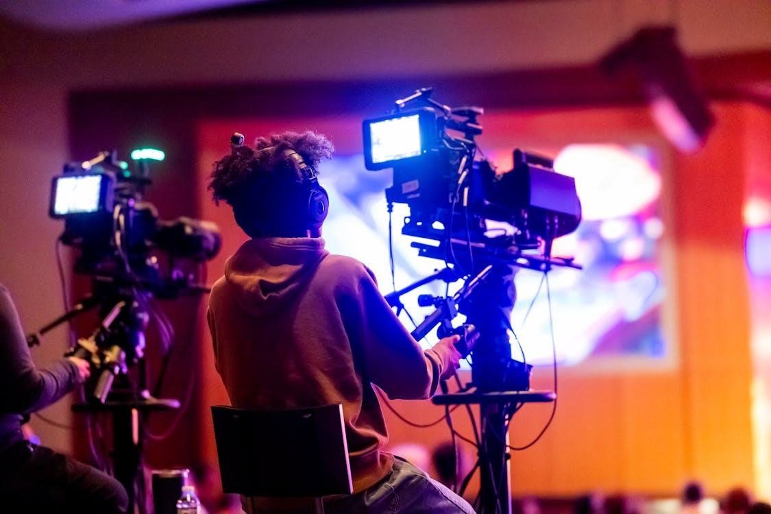 Two people using video cameras