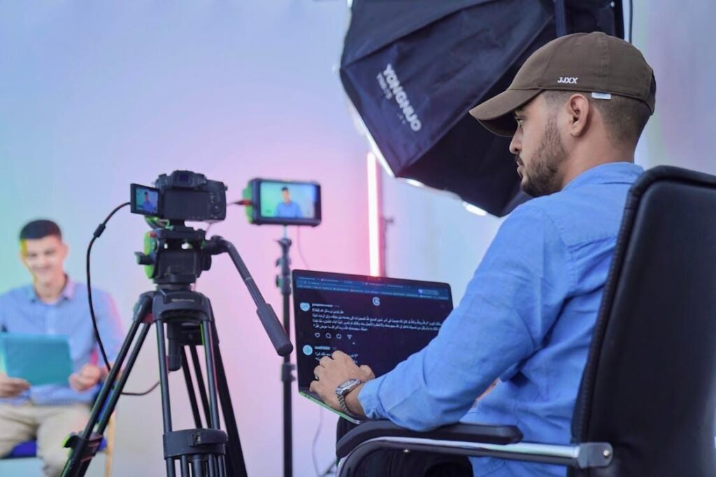 A person using a laptop attached to a camera