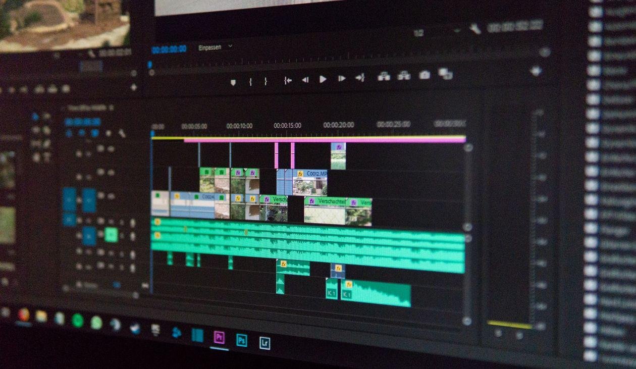 an Adobe Premiere Pro timeline showing layered video and audio tracks on a dark editing interface.