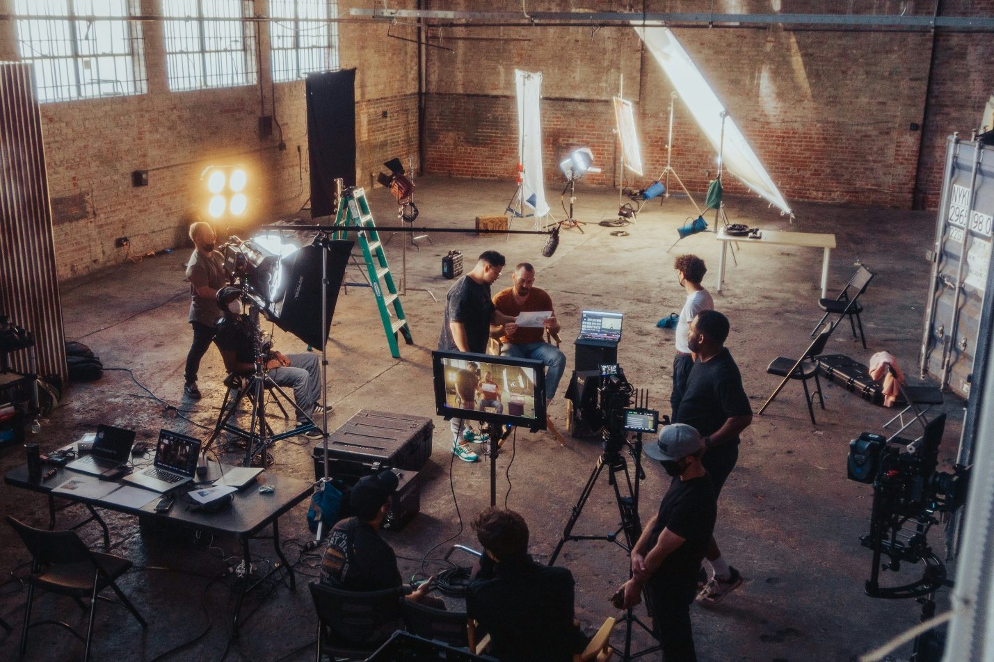 people gathered around a professional camera setup on a film set